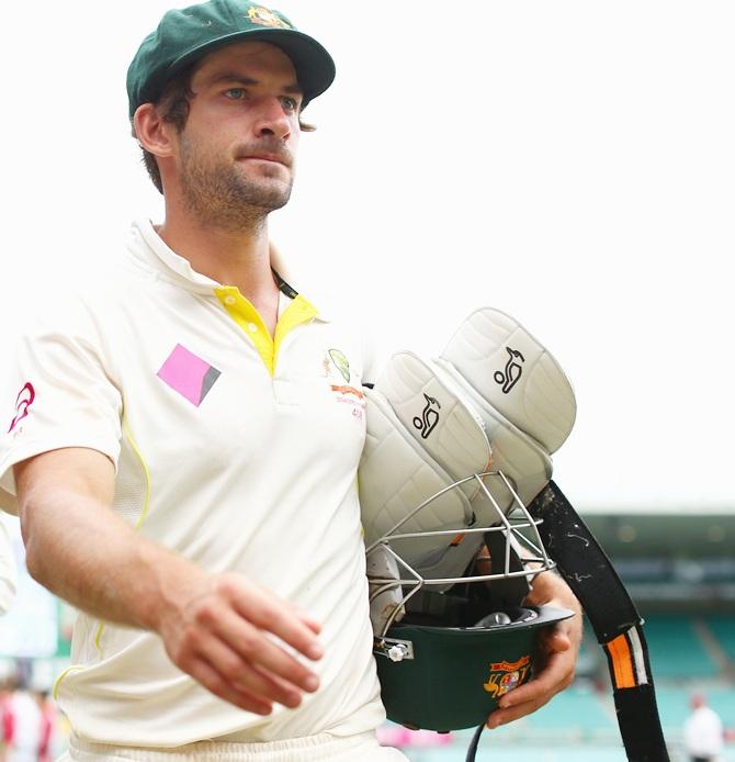 Joe Burns of Australia walk off the field 