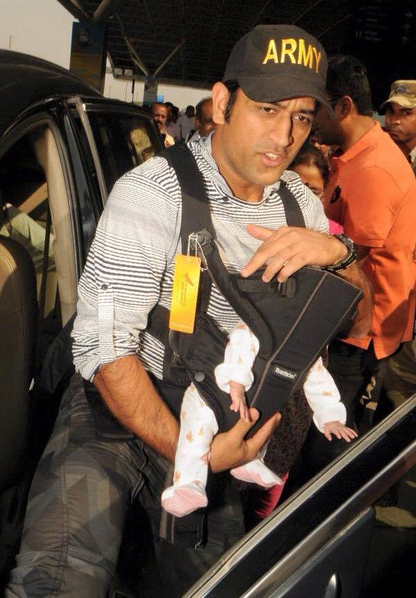 India ODI captain Mahendra Singh Dhoni shields daughter Ziva from the media on Saturday