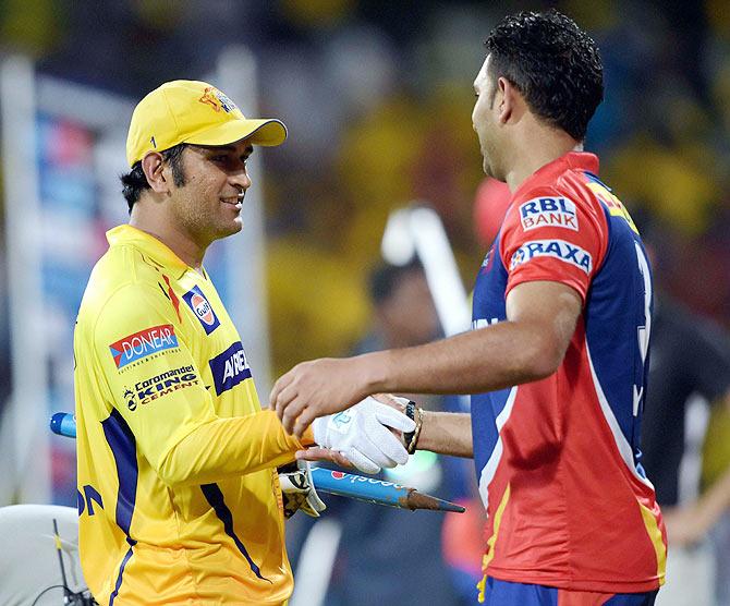 Chennai Super Kings’ Skipper Mahendra Singh Dhoni with Delhi Daredevils' Yuvraj Singh after their match at MAC Stadium in Chennai on Thursday