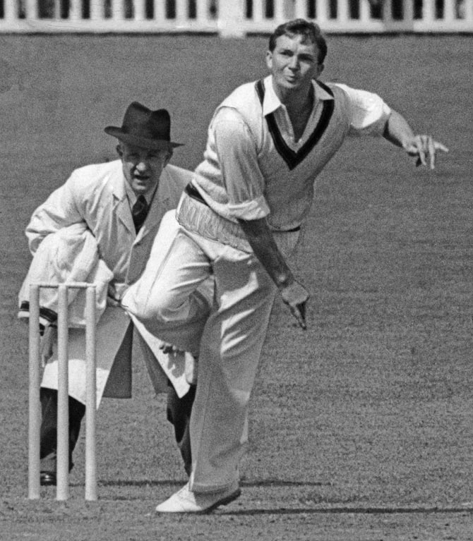 Australian cricketer and team captain Richie Benaud bowls