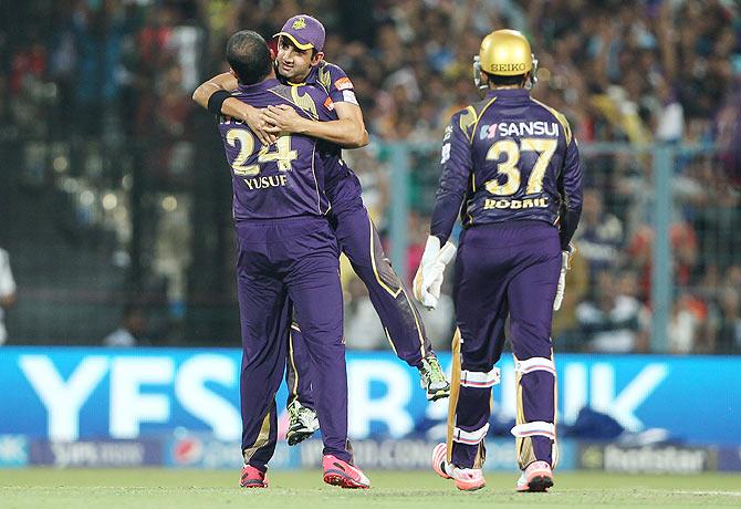 Kolkata Knight Riders' Yusuf Pathan celebrates with captain Gautam Gambhir after dismissing Royal Challengers Bangalore's Mandeep Singh