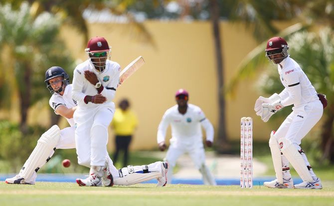 England's Joe Root  pulls a delivery behind square off the bowling of West Indies' Sulieman Benn as wicketkeeper Denesh Ramdin looks on