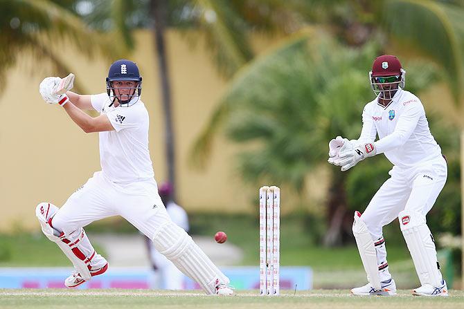 Gary Ballance plays to the offside as Windies wicketkeeper Denesh Ramdin looks on