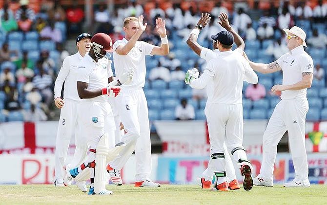 England's Stuart Broad celebrates with teammates after taking the wicket of West Indies' Kemar Roach