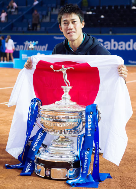 Japan's Kei Nishikori poses with the Barcelona Open Banc Sabadell trophy after defeating Spain's Pablo Andujar in the final at the Real Club de Tenis Barcelona on Sunday