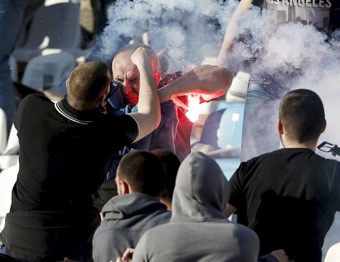 Red Star Belgrade and Partizan Belgrade fans clash in the stadium on April 25. Thirty-five police officers were hurt and 41 fans arrested in a violent Belgrade derby between Red Star and Partizan