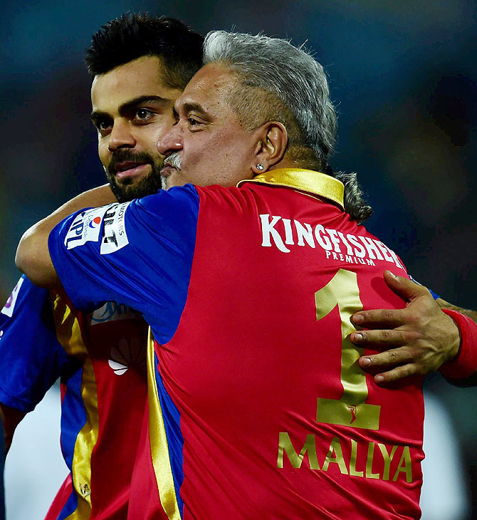 Royal Challengers Bangalore's captain virat Kohli celebrates with team owner Vijay Mallya after their win over Delhi Daredevils in the Indian Premier League at Feroz Shah Kotla Stadium on Sunday