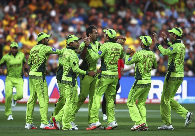 Pakistan players celebrate after a fall of a wicket
