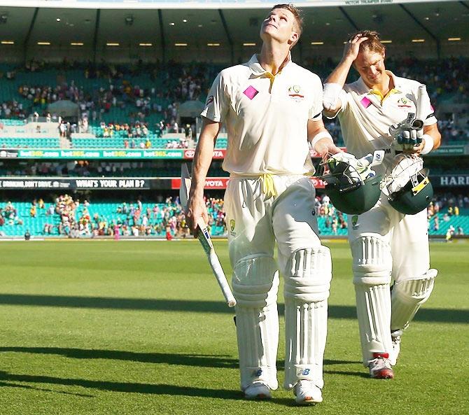 Australia's Steve Smith and Shane Watson walk off the field