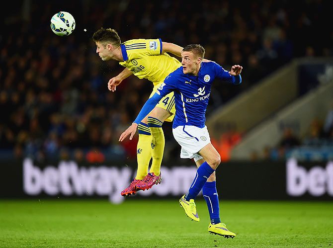 Chelsea's Gary Cahill heads the ball clear of Leicester City's Jamie Vardy