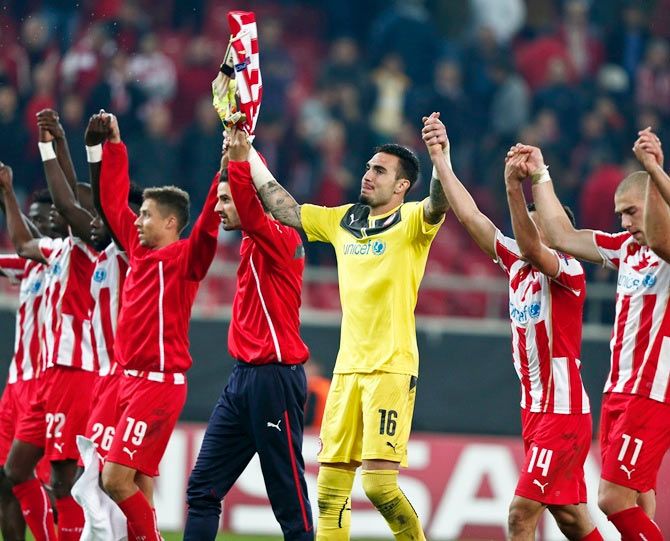 Olympiakos players celebrate their win during their Champions League match.
