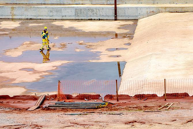 Workers walk inside the Deodoro Sports Complex for the Rio 2016 Olympic Games in Ricardo de Albuquerque neighborhood in Rio de Janeiro, Brazil