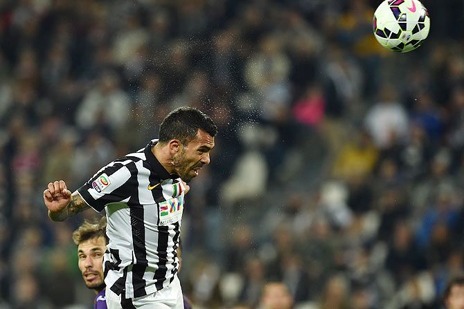Carlos Tevez of Juventus FC heads to score during their Serie A match against ACF Fiorentina at Juventus Arena in Turin on Wednesday