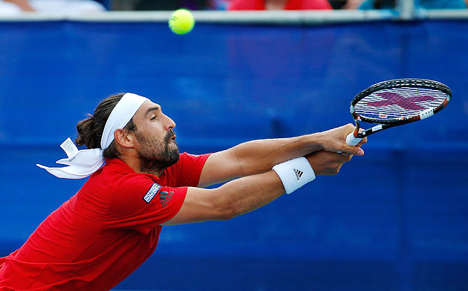 Marcos Baghdatis is aced by John Isner