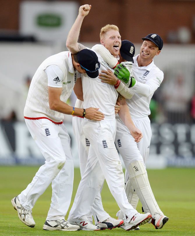 England's Ben Stokes celebrates with teammates Steven Finn and Jos Buttler after dismissing Australia's Mitchell Johnson on Day 2 of the 4th Investec Ashes Test at Trent Bridge in Nottingham on Friday