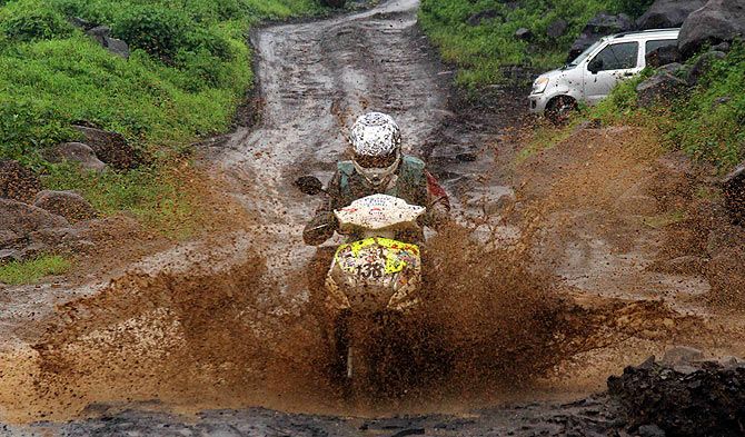 Venkatesh Shetty, astride his Honda Deo, negotiates the challenging track at the Gulf Monsoon Scooter Rally along the backwoods of Navi Mumbai on August 10