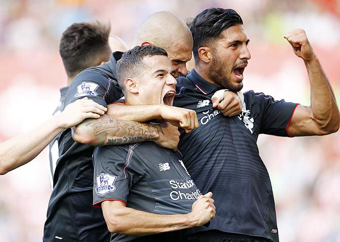 Liverpool's Philippe Coutinho celebrates with Martin Skrtel and Emre Can after scoring against Stoke City during their English Premier League match at Britannia Stadium on Saturday