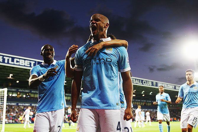 Vincent Kompany of Manchester City (right) is ecstatic as he celebrates their third goal of the night against West Bromwich Albion
