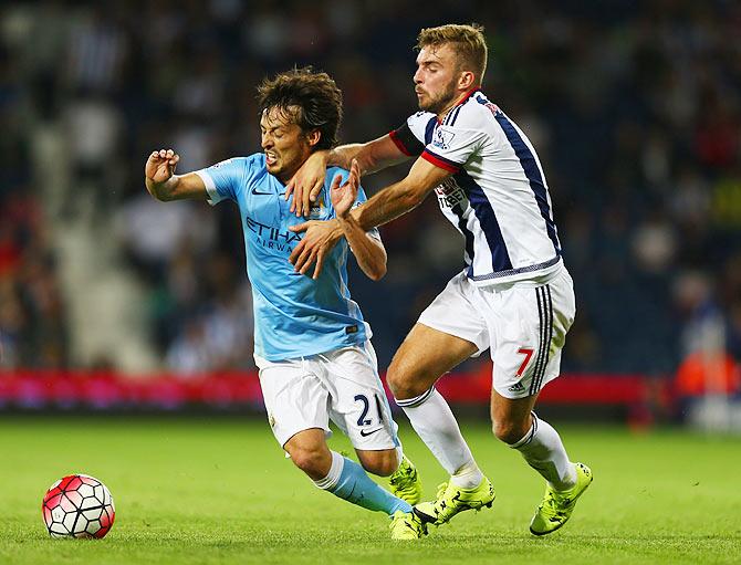 Manchester City's David Silva takes on West Bromwich Albion's James Morrison