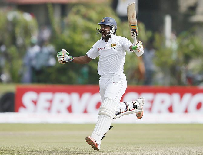 Dinesh Chandimal celebrates on completing his century against India on Day 3 of the first Test in Galle on Friday