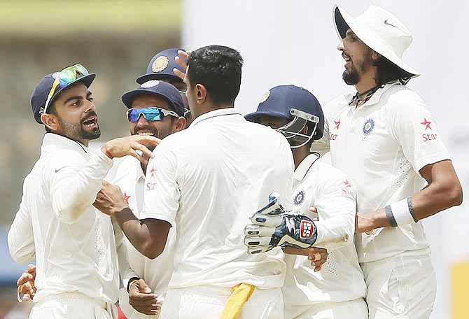 India's captain Virat Kohli (left) celebrates with teammates including after the dismissal of Sri Lanka's Kumar Sangakkara