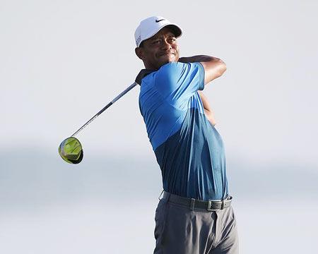 Tiger Woods hits his tee shot on the 16th hole during the continuation of the second round of the 2015 PGA Championship golf tournament