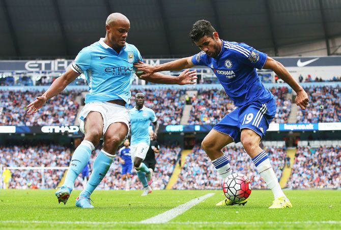 Chelsea'S Diego Costa holds off a challenge by Manchester City's Vincent Kompany on Sunday