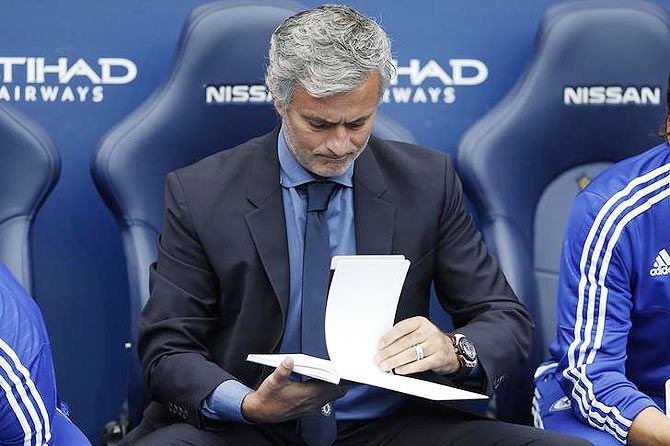 Chelsea manager Jose Mourinho browses through his notes during the Premier League match between Chelsea and Manchester City on Sunday