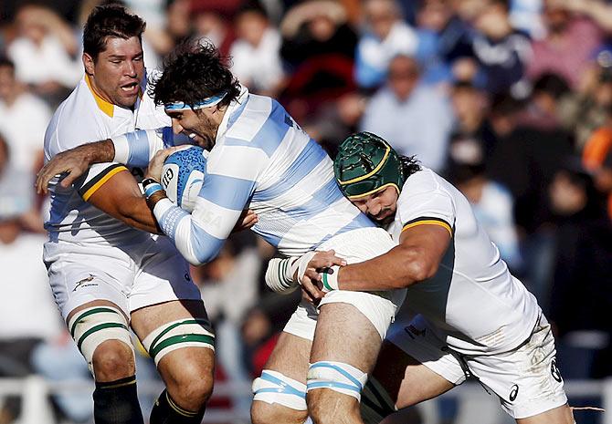 Argentina's Juan Martin Fernandez Lobbe (centre) is tackled by South Africa's Willem Alberts (left) and Victor Matfield during their rugby union Test match in Buenos Aires, Argentina on Saturday, August 15