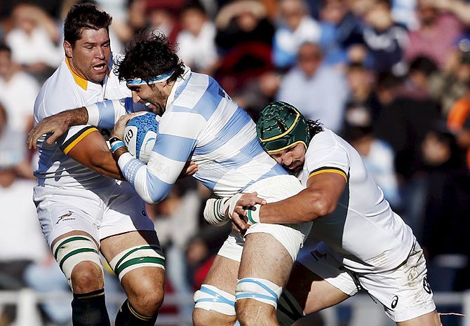 Argentina's Juan Martin Fernandez Lobbe (centre) is tackled by South Africa's Willem Alberts (left) and Victor Matfield during their rugby union Test match in Buenos Aires, Argentina on Saturday, August 15