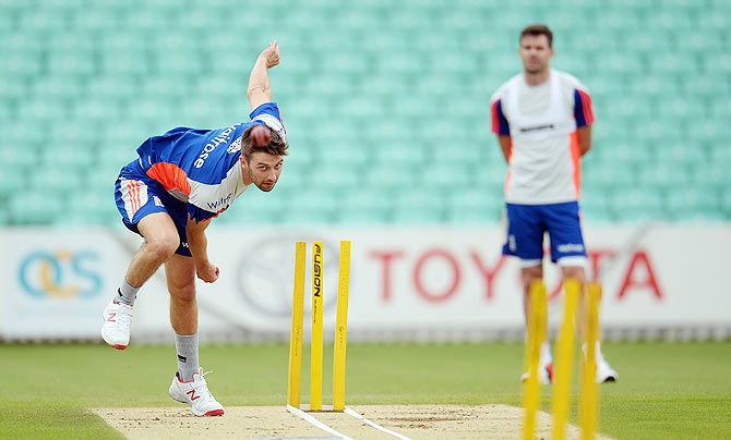 England's Mark Wood bowls during a training session as James Anderson watches in the background at Kia Oval on Tuesday