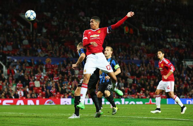 Manchester United's Chris Smalling wins a header against Club Brugge's Laurens De Bock