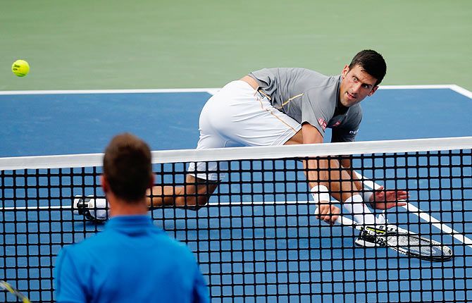 Serbia's Novak Djokovic returns a shot to France's Benoit Paire