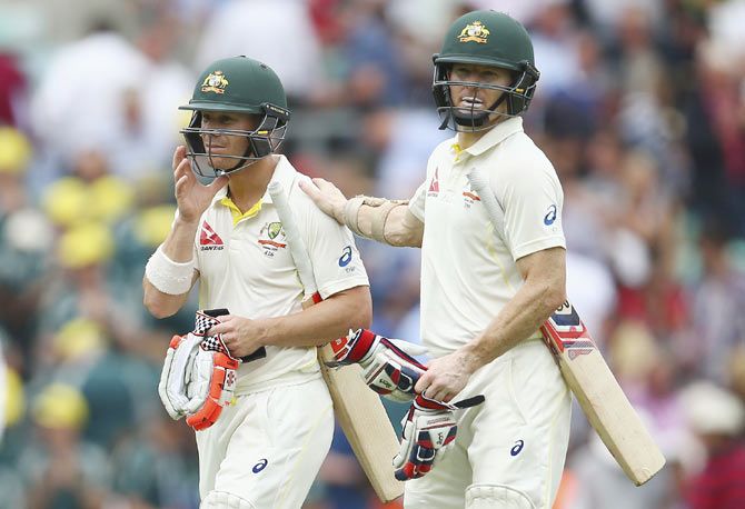 Australia openers David Warner and Chris Rogers walk from the ground at lunch on Day 1 of the 5th Ashes Test at The Kia Oval in London on Thursday