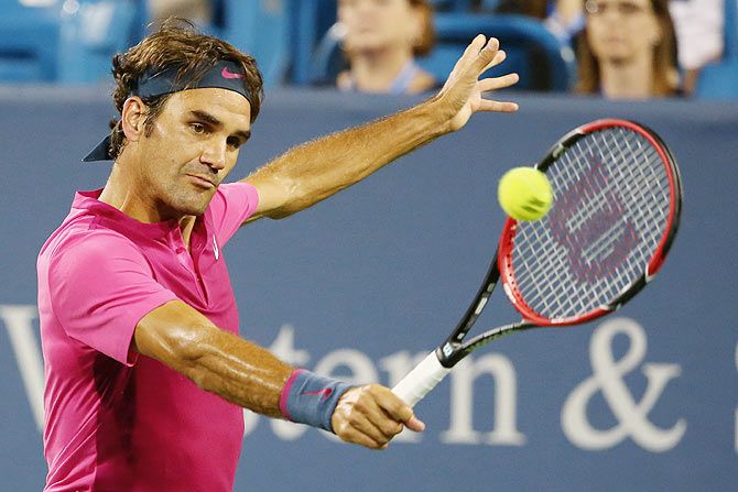 Switzerland's Roger Federer returns a shot to South Africa's Kevin Anderson