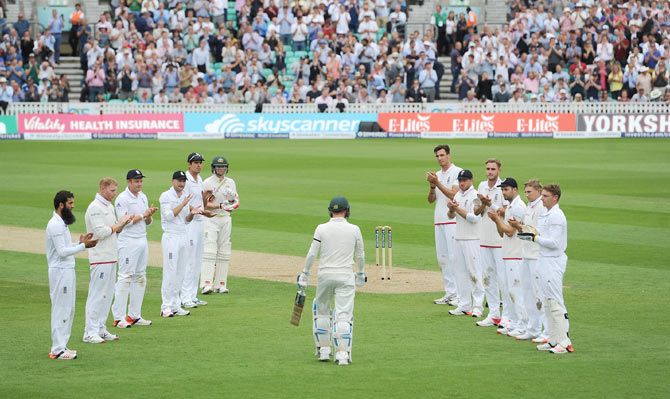England players form a guard of honour as Australian captain Michael Clarke walks out to bat in his final Test on Thursday