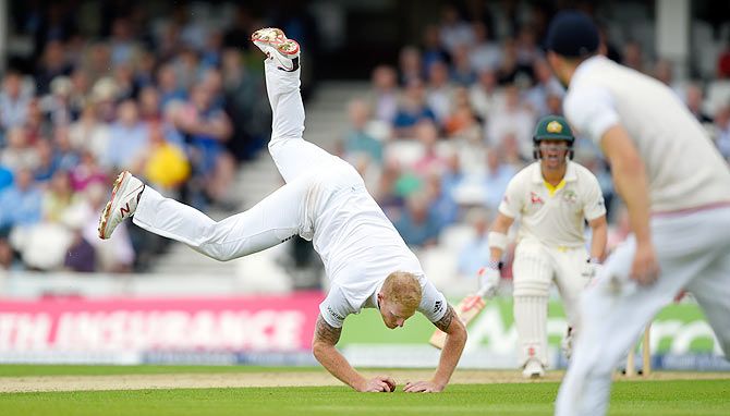 Australia batsman David Warner looks on as England bowler Ben Stokes fields off his own bowling