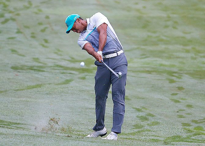 Tiger Woods plays his second shot on the 11th hole
