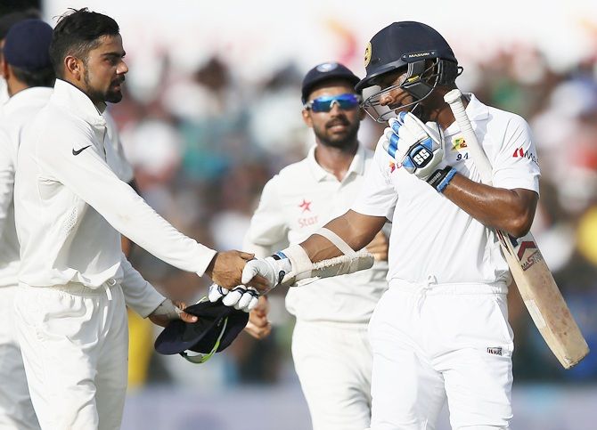 Sri Lanka's Kumar Sangakkara, right, shakes hands with India's captain Virat Kohli