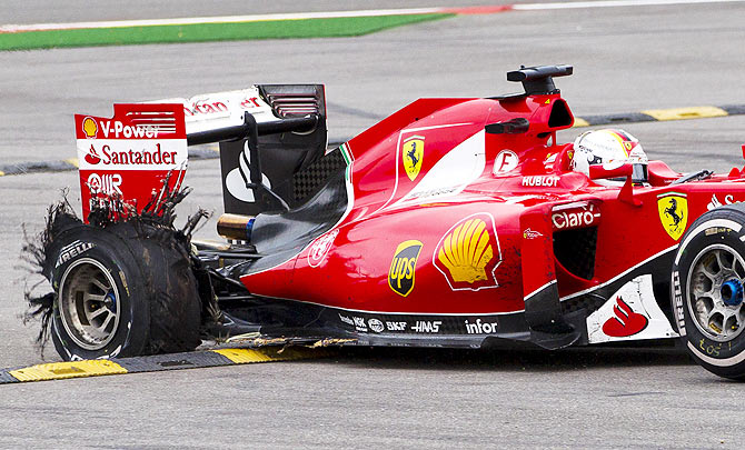 Ferrari Formula One driver Sebastian Vettel steers his car to the safety area after a tyre failure during the Belgian F1 Grand Prix in Spa-Francorchamps, Belgium, on Sunday, August 23