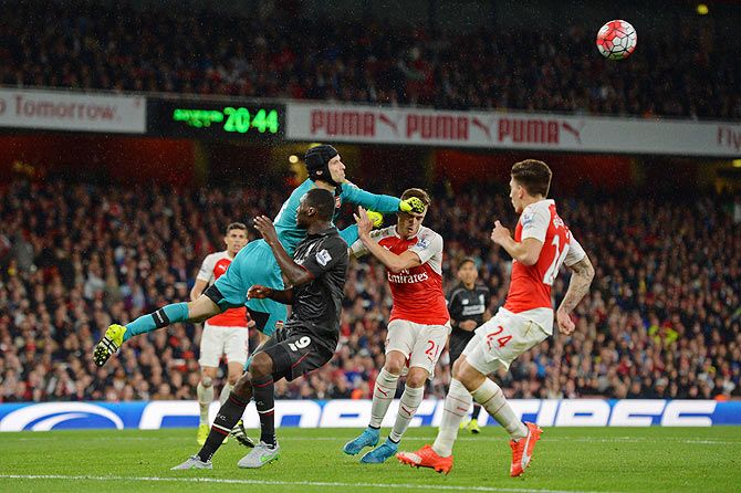 Arsenal's Petr Cech and Calum Chambers thwart Liverpool's Christian Benteke's effort during their English Premier League match on Monday