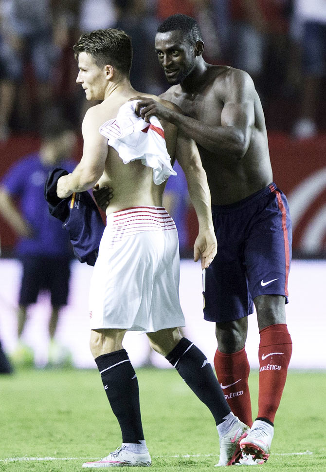 Sevilla FC's Kevin Gameiro (left) exchanges his jersey with Atletico de Madrid's Jackson Arley Martinez after their La Liga match at Estadio Ramon Sanchez Pizjuan in Seville on Sunday