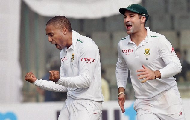 South Africa's Dane Piedt celebrates with teammate Dean Elgar the wicket of Indian batsman Murali Vijay during the fourth Test match in New Delhi