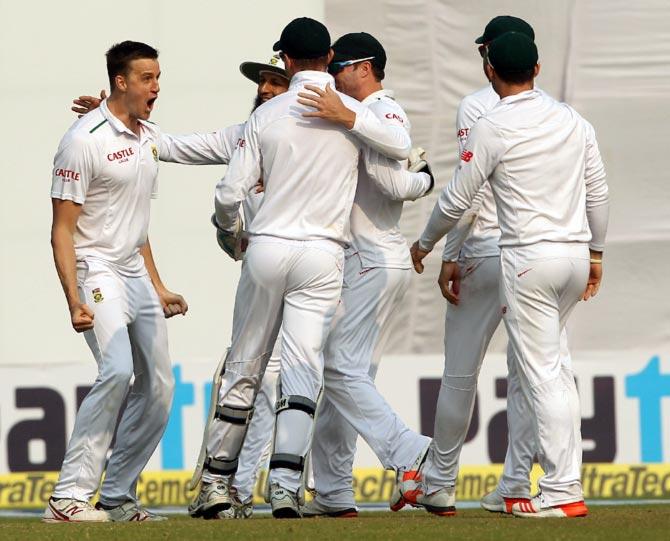 Morne Morkel (left) celebrates with team mates after taking the wicket of Murali Vijay