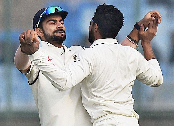 India captain Virat Kohli and his teammate Ravindra Jadeja celebrate the dismissal of Hashim Amla of South Africa during final day of the fourth Test match at Feroz Shah Kotla Stadium in New Delhi on Monday