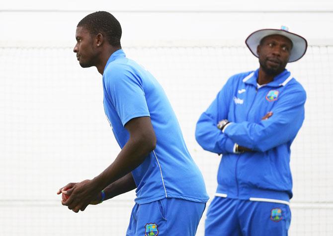 West Indies bowling consultant Courtney Ambrose looks on as Jason Holder bowls in the nets during a West Indies training session at Blundstone Arena in Hobart on Tuesday