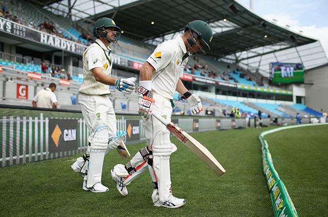 David Warner and Joe Burns of Australia run onto the field 