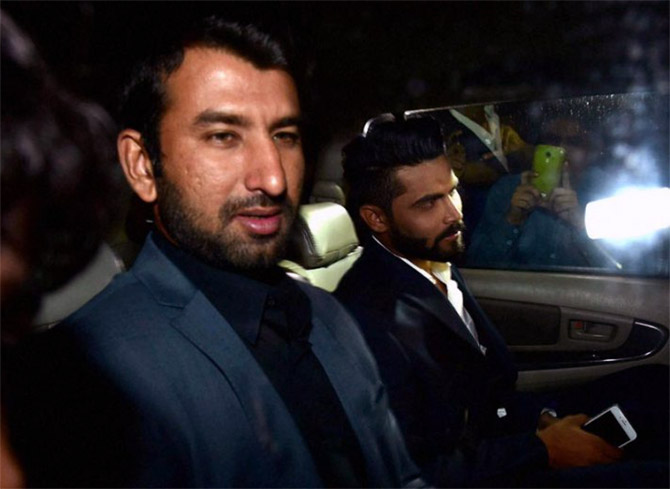 Rohit Sharma's teammates Cheteshwar Pujara (left) and Ravindra Jadeja arrive for the wedding 