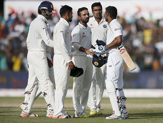 Kumar Sangakkara shakes hands with the Indians in his final Test innings in Colombo