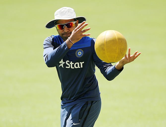Rohit Sharma warms up during an India training session 